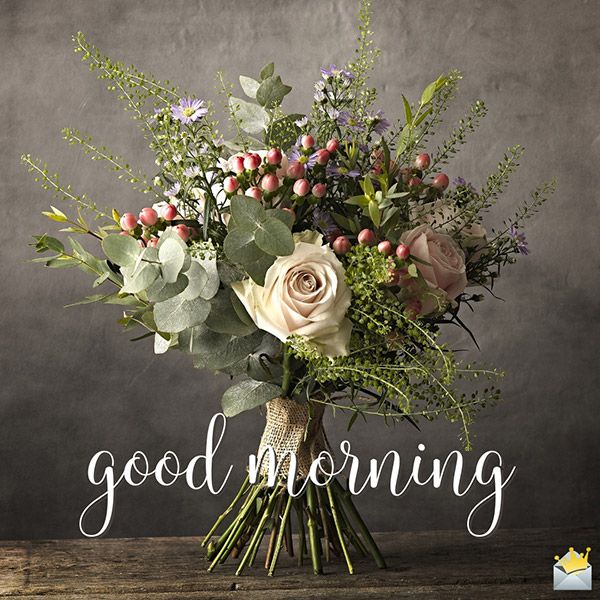 This may contain a bouquet of flowers sitting on top of a wooden table with the words good morning