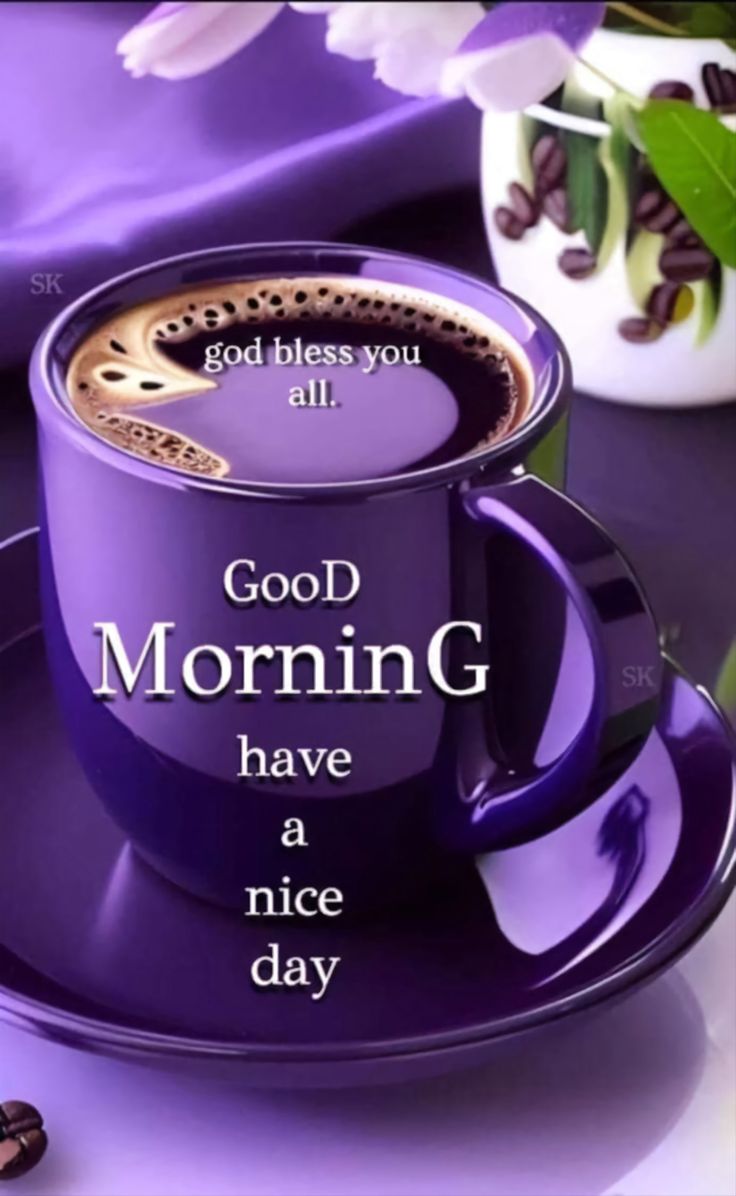 This may contain a purple coffee cup and saucer sitting on top of a table next to flowers